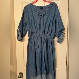 High low, denim colored dress with rolled sleeves and lace up v neck